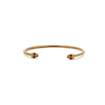 Shop Alexander Mcqueen Twin Skull Gold-tone Bracelet