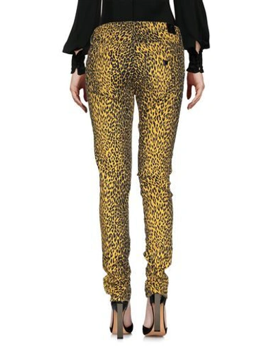Shop Guess Pants In Yellow