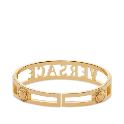Shop Versace Cutout Bangle Bracelet In Gold