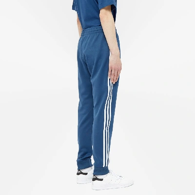 Shop Adidas Originals Adidas Superstar Track Pant In Blue