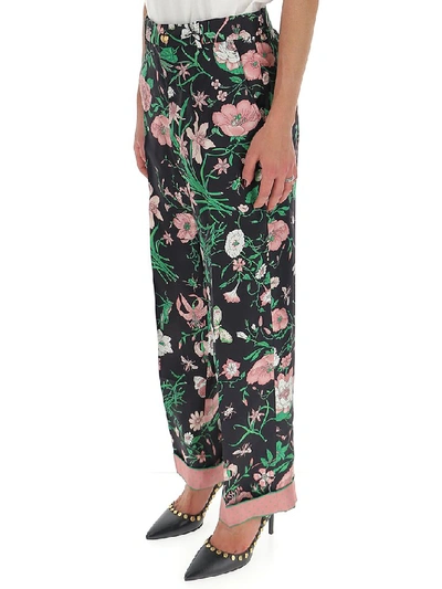 Shop Gucci Floral Printed Trousers In Multi