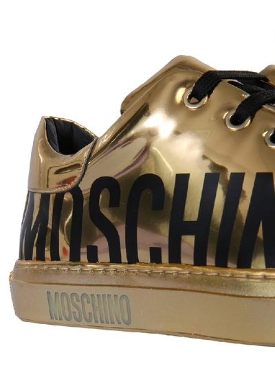 Shop Moschino Logo Sneakers In Gold