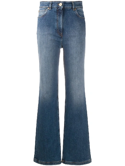 Shop Versace Faded-effect Flared Jeans In Blue