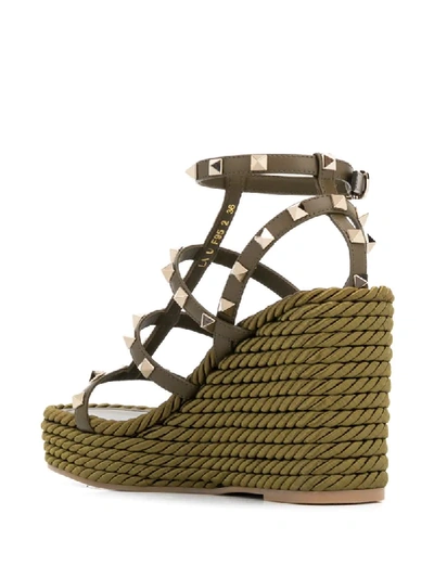 Shop Valentino Rockstud Rope Wedge Sandals In Green