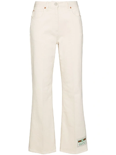 Shop Gucci Logo Patch Flared Jeans In White