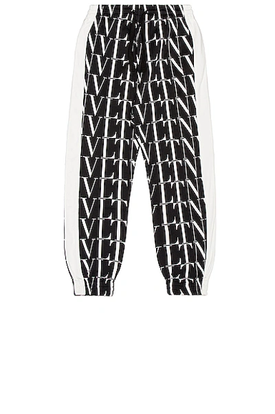 Shop Valentino Vltn Times Print Trousers In Black & Vltn Times White