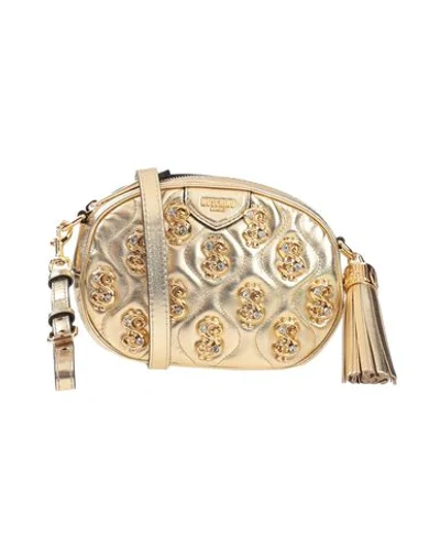 Shop Moschino Cross-body Bags In Gold