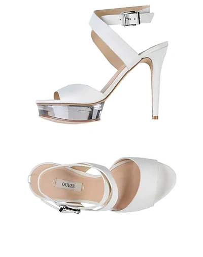 Shop Guess Sandals In White