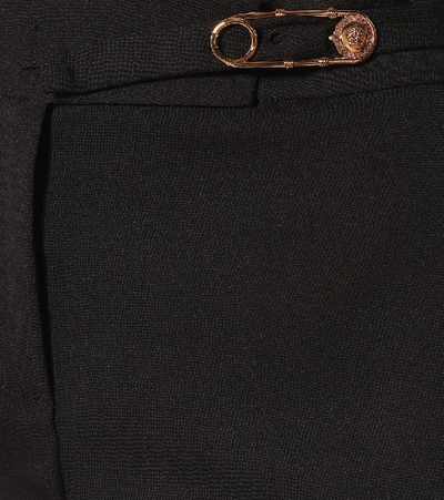 Shop Versace Embellished Stretch-wool Pants In Black