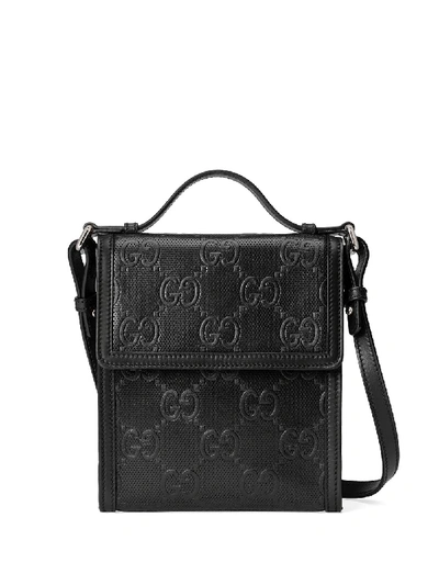 Shop Gucci Embossed Gg Motif Messenger Bag In Black