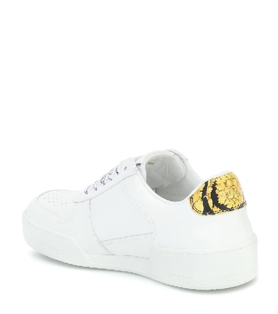 Shop Versace Leather Sneakers In White