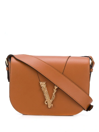 Shop Versace Foldover Saddle Bag In Brown