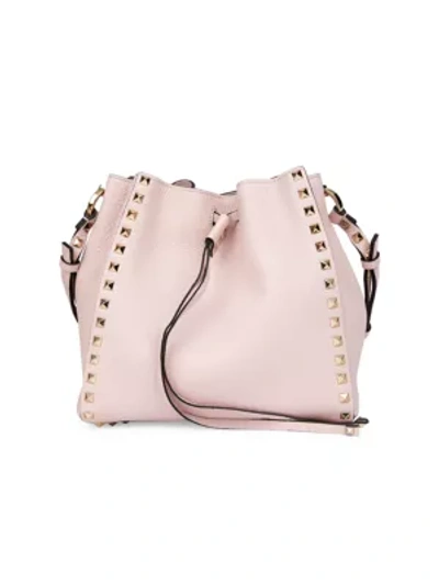 Shop Valentino Garavani Small Rockstud Leather Bucket Bag In Rose Quartz
