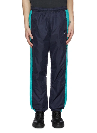 Shop Acne Studios Face Patch Panel Outseam Nylon Track Pants In Multi-colour