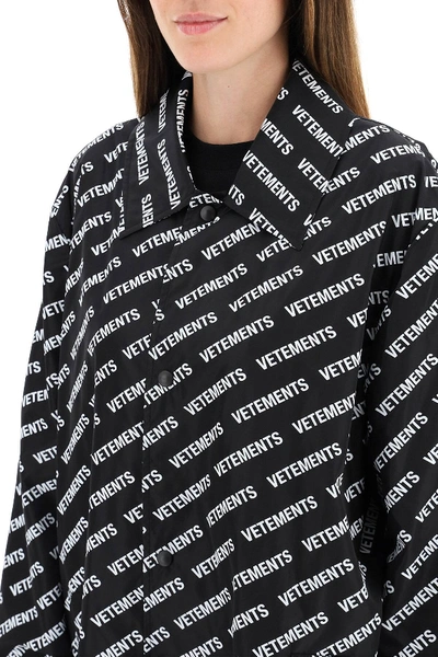 Shop Vetements All Over Logo Raincoat In Black/white