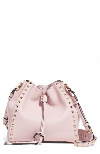 Shop Valentino Small Rockstud Leather Bucket Bag In Rose Quartz