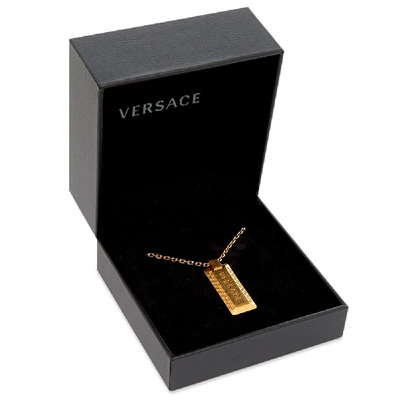 Shop Versace Logo Pendant And Necklace In Gold