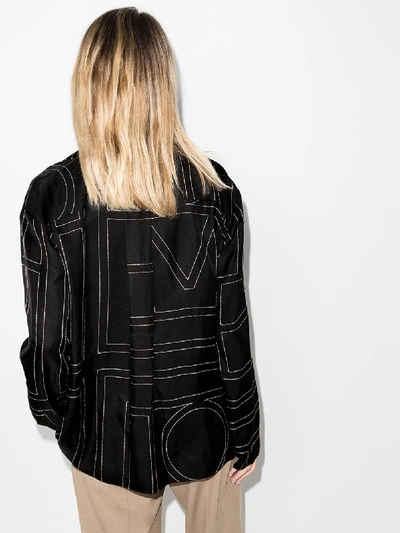 Shop Totême Sanville Monogram Silk Blouse In Black