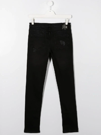 Shop Moschino Teen Distressed Skinny Jeans In Black