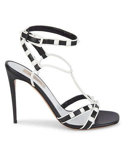 Shop Valentino Rockstud Strappy Leather Stiletto Sandals In Black White