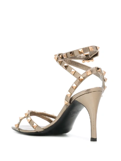 Shop Valentino Rockstud Sandals In Metallic