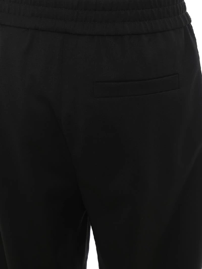 Shop Moschino Logo Band Trousers In Black