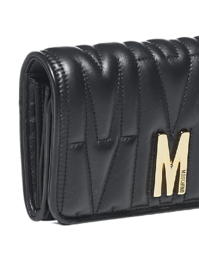 Shop Moschino M Plaque Quilted Clutch Bag In Black