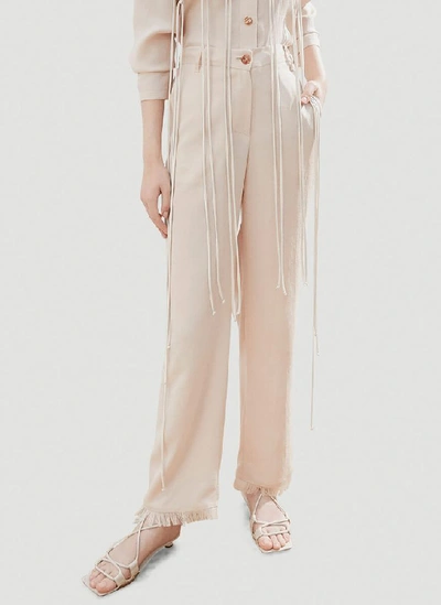 Shop Nanushka Theo Frayed Trousers In Beige