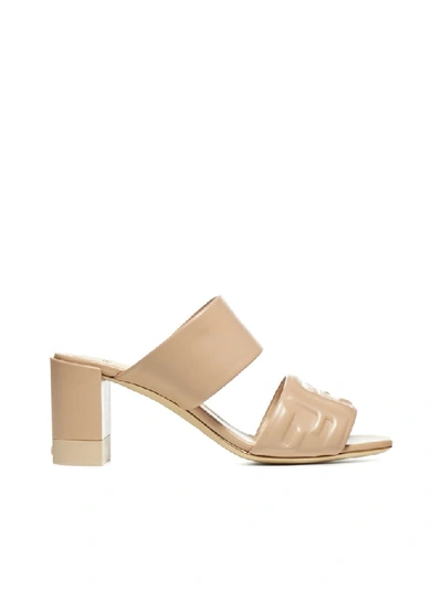 Shop Fendi Logo Embossed Mules In Beige