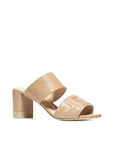 Shop Fendi Logo Embossed Mules In Beige