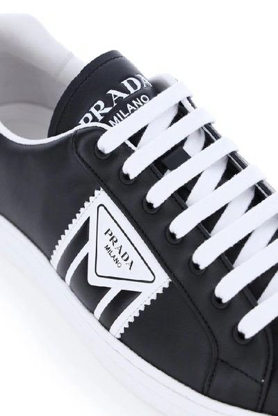 Shop Prada Embossed Logo Sneakers In Black