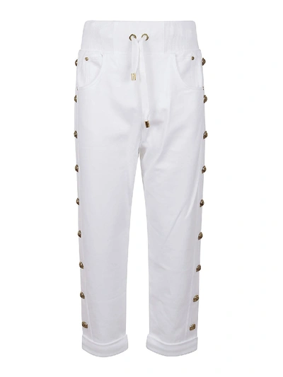 Shop Balmain White Pants Featuring Golden Logo Buttons