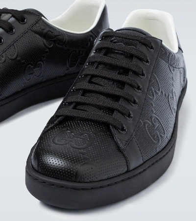 Shop Gucci Ace Gg Embossed Sneakers In Black