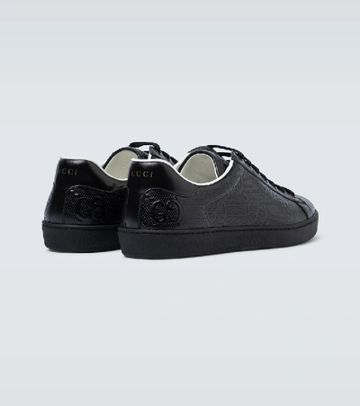 Shop Gucci Ace Gg Embossed Sneakers In Black