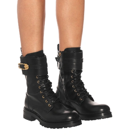 Shop Versace Safety Pin Leather Ankle Boots In Black