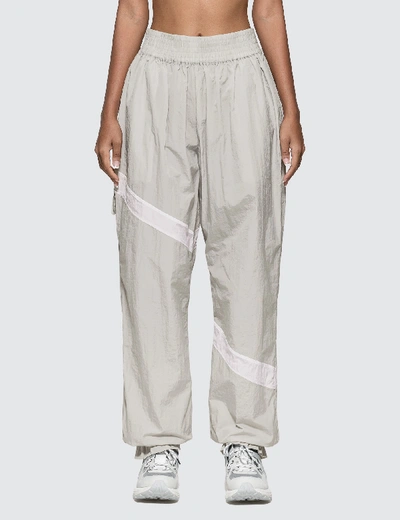 Shop Ganni Crinkled Tech Track Pants In Beige