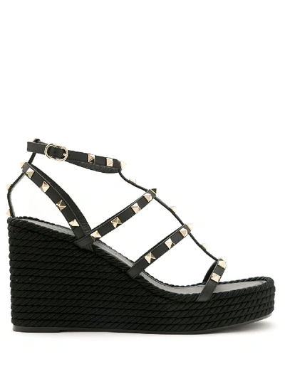 Shop Valentino Rockstud Strappy Wedge Sandals In Black