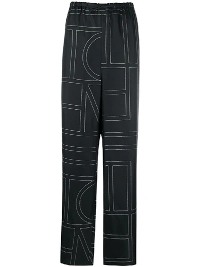Shop Totême Vizelle Monogram-print Trousers In Black ,white