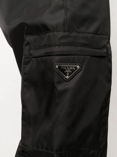 Shop Prada Logo Plaque Gabardine Trousers In Black