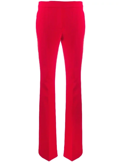 Shop Moschino Flared High-waisted Trousers In Red