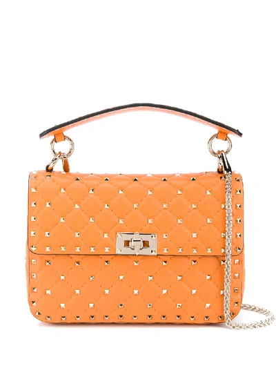 Shop Valentino Rockstud Spike Shoulder Bag In Orange