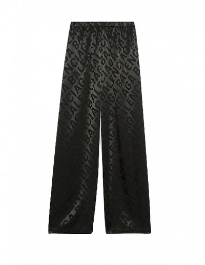 Shop Balenciaga Allover Large Logo Trousers In Black