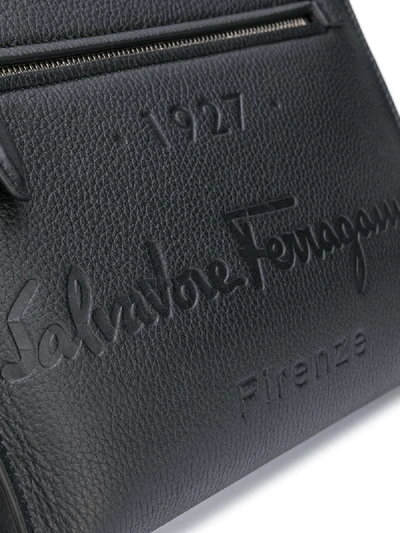Shop Ferragamo Debossed-logo Clutch Bag In Black
