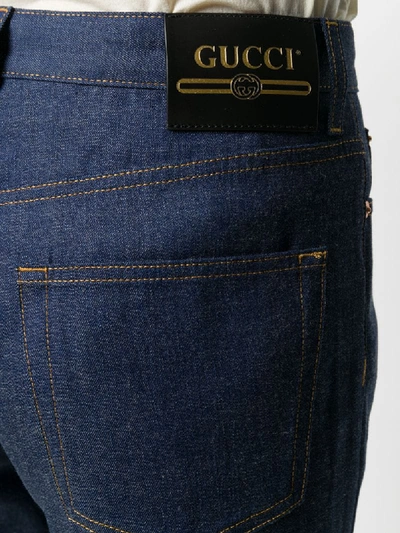Shop Gucci Flared Jeans With Logo Patch At Leg In Blue