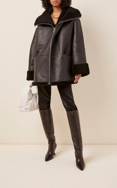 Shop Totême Menfi Oversized Shearling Coat In Black