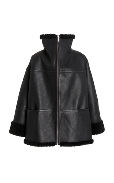 Shop Totême Menfi Oversized Shearling Coat In Black