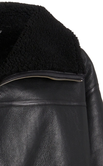 Shop Totême Menfi Oversized Shearling Coat In Black
