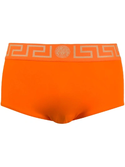 Shop Versace Greca-print Swimming Trunks In Orange