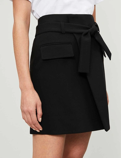 Shop Maje Josina Wrapover Stretch-twill Mini Skirt In Black