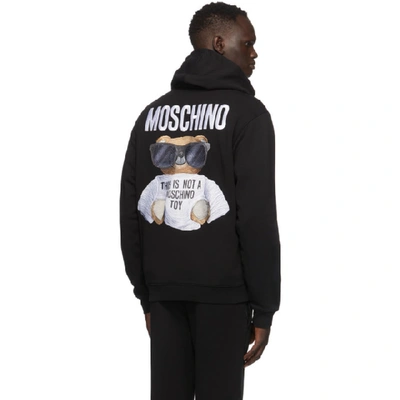 Shop Moschino Black Embroidered Logo Hoodie In V1555 Black
